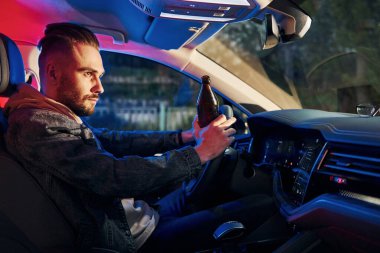 Siyah ve kırmızı polis ışıkları. İçkili araba kullanma. Arabasının içinde şık giyinmiş, tıraşsız yakışıklı bir adam..