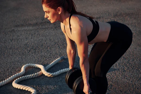 Ağırlık kaldırıyorum. Spor giyinen kadınların akşam vakti spor salonunda spor günleri olur..