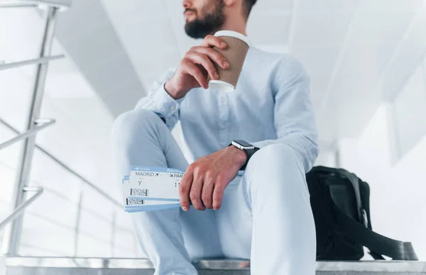Holding Plane Tickets Hand Sitting Stairs Waiting Young Passenger Formal — Stockfoto
