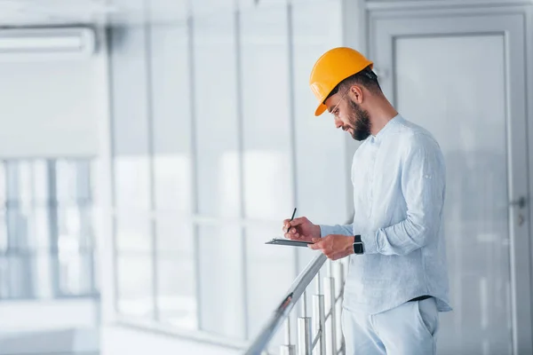 Holding Notepad Engineer White Clothes Orange Protective Hard Hat Standing — стоковое фото