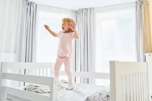 Jumping Bed Cute Little Girl Casual Clothes Indoors Home Daytime — Stock Photo, Image