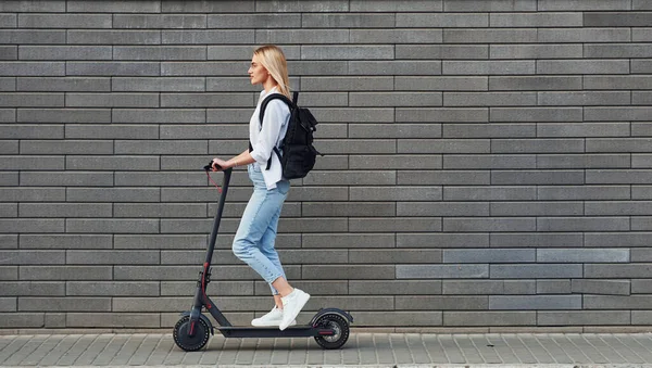 Side View Beautiful Blonde Casual Clothes Riding Electric Schooter Outdoors — Fotografia de Stock