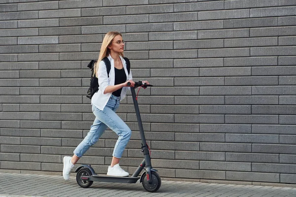 Side View Beautiful Blonde Casual Clothes Riding Electric Schooter Outdoors — Fotografia de Stock