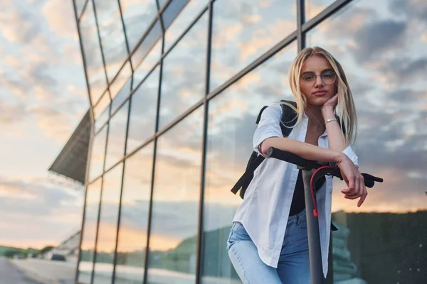Modern Business Building Beautiful Blonde Casual Clothes Riding Electric Schooter — 스톡 사진