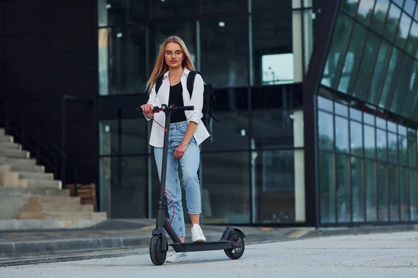 Business Building Beautiful Blonde Casual Clothes Riding Electric Schooter Outdoors — 스톡 사진