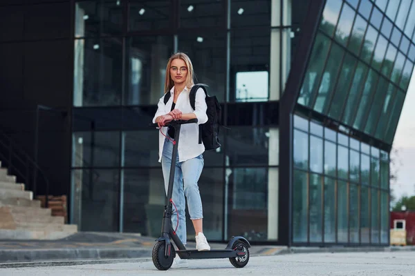 Business Building Beautiful Blonde Casual Clothes Riding Electric Schooter Outdoors — ストック写真