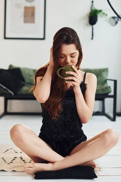 Young Woman Pajamas Sitting Floor Indoors Daytime Cup Drink — Stock Photo, Image