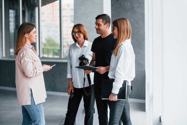 Group of business people in formal clothes that standing indoors.