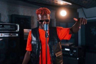 Ses alıştırması yapıyorum. Genç Afrikalı Amerikalı sanatçı bir kayıt stüdyosunda prova yapıyor..