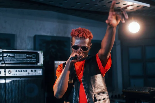 Ses alıştırması yapıyorum. Genç Afrikalı Amerikalı sanatçı bir kayıt stüdyosunda prova yapıyor..