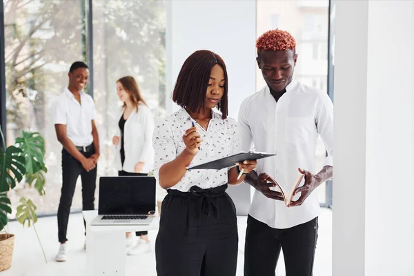 Group of african american business people working in office together.