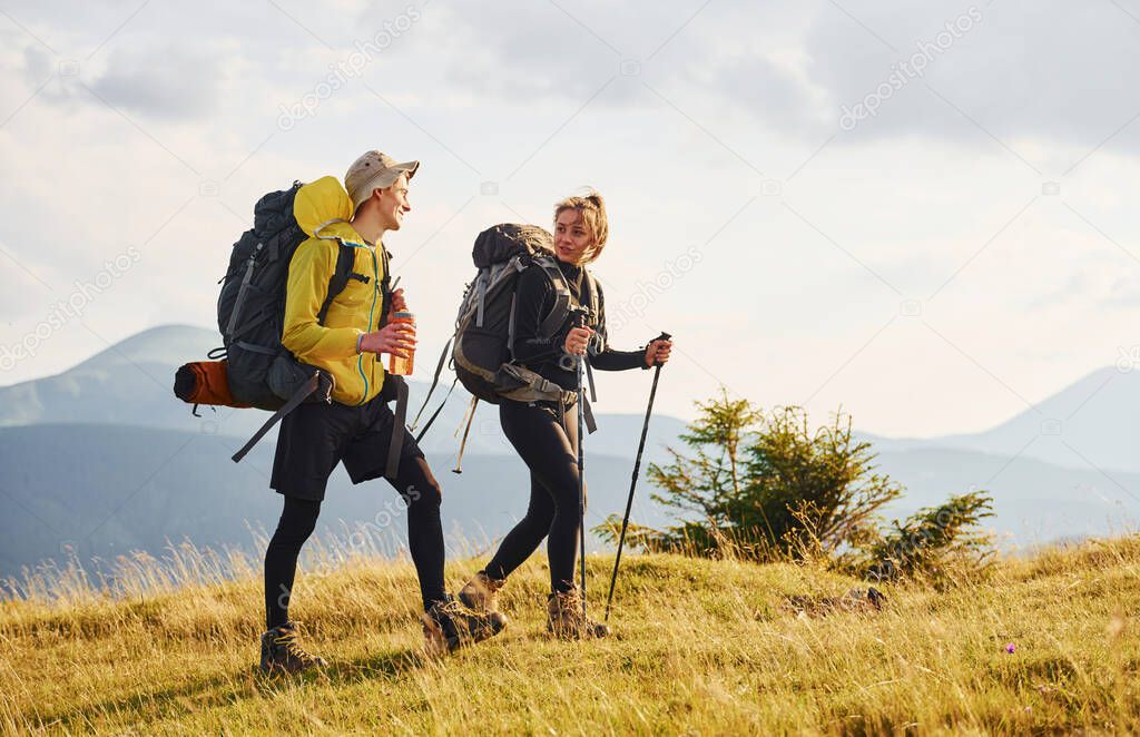 Beautiful young people travel together. Majestic Carpathian Mountains. Beautiful landscape of untouched nature.