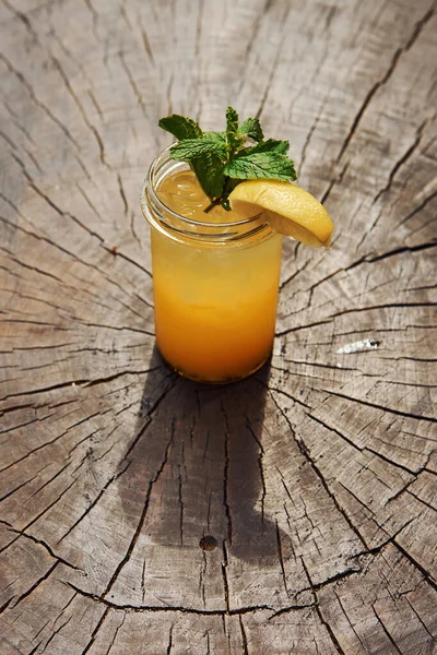 加柠檬和薄荷坐在木制桌子上的夏季新鲜酒精鸡尾酒近景 — 图库照片