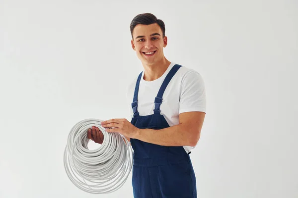 Holds Cable Male Worker Blue Uniform Standing Studio White Background — Stock Photo, Image