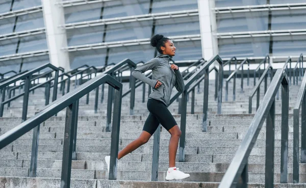 活跃的跑步者身穿运动服的年轻非洲裔美国妇女白天在室外锻炼 — 图库照片