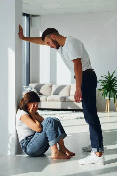 Violent aggressive young man threatening his girlfriend at home.