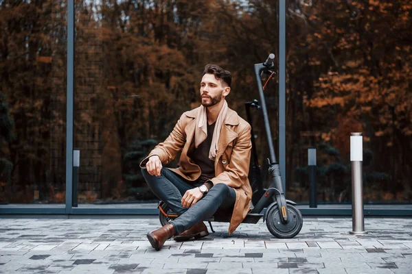 Tegen Bouwen Met Elektrische Scooter Jonge Man Model Modieuze Kleding — Stockfoto