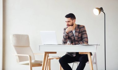 Laptop kullanıyor. Takım elbiseli genç bir iş adamı. Başarı kavramı.