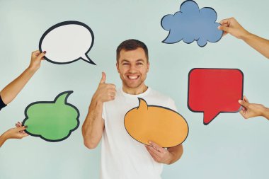 Birçok farklı düşünce. Stüdyoda duran adam mesaj için boş tabelalarla.