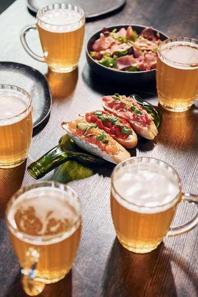 Close up view of food and beer on the table.