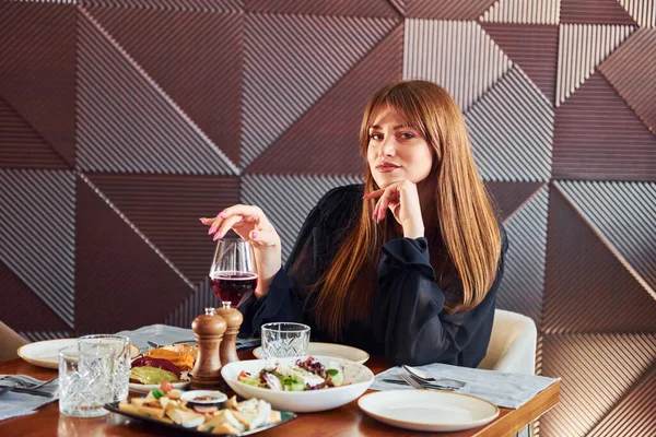 Woman have luxury dinner. Indoors of new modern luxury restaurant.