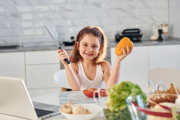 Happy Little Girl Sits Kitchen Food Laptop Table — Stock Photo, Image