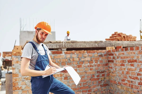 Rušný Den Mladý Stavební Dělník Uniformě Zaneprázdněn Nedokončeném Domě — Stock fotografie