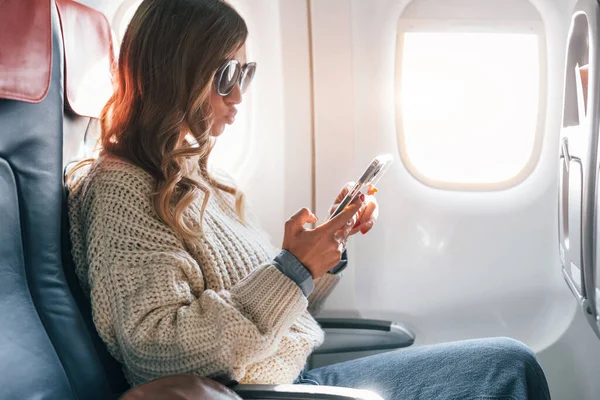 Sitting Phone Hands Young Female Passanger Casual Clothes Plane — Stock Photo, Image