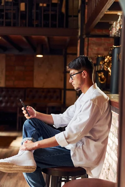 Man Casual Clothes Sitting Pub Phone Hand Stock Image