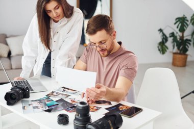 Günlük kıyafetli iki fotoğrafçı gündüzleri evde çalışıyor..