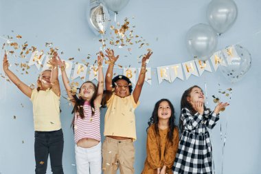 Balonlar ve konfetiler. Çocuklar doğum günü partisini evde kutlarken size iyi eğlenceler..