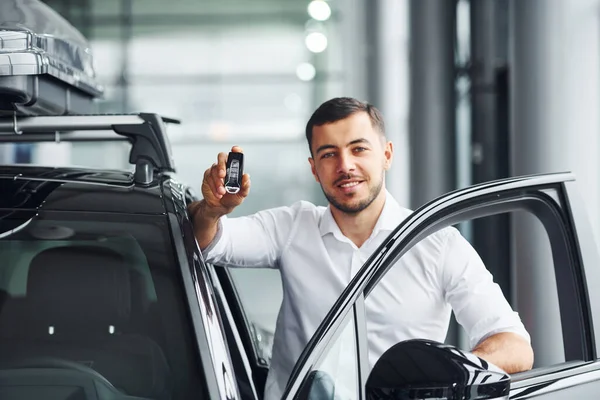 Holds Keys Young Man White Shirt Indoors Modern New Automobile — Stock Photo, Image