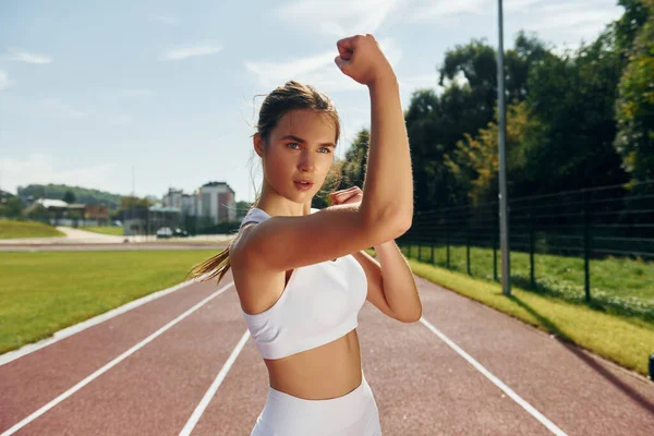 Self defence conception. Young woman in sportive clothes is exercising outdoors.