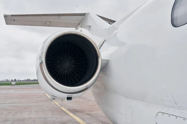 Close up view. Turboprop aircraft parked on the runway at daytime.