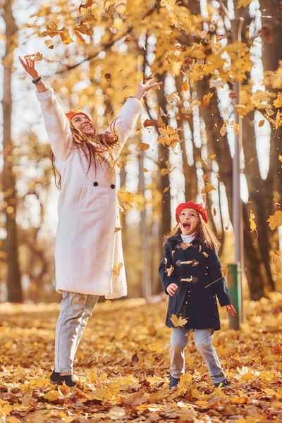 Throwing Leaves Air Mother Her Little Daughter Having Walk Autumn — Stock Photo, Image