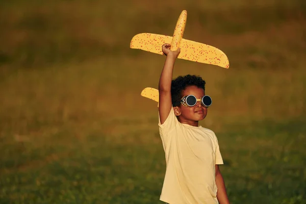 レトロスタイルのパイロットサングラス アフリカ系アメリカ人の子供は夏の昼間にフィールドで楽しんでいます — ストック写真