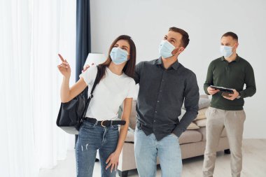 Adam, genç çifte daire seçmesinde yardım ediyor..