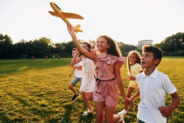 Playing Toy Plane Group Happy Kids Outdoors Sportive Field Daytime — Stock Photo, Image