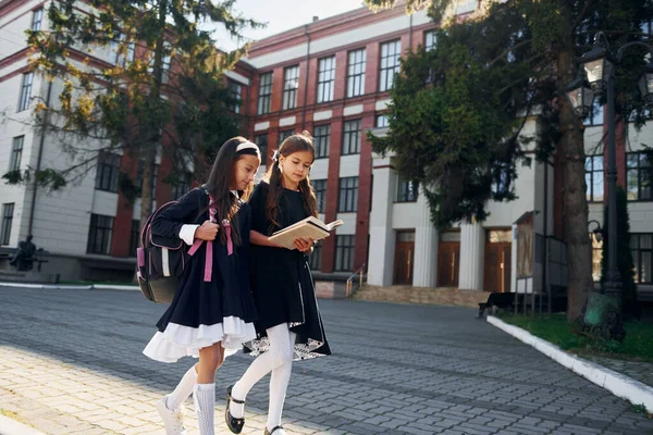 友情の概念 2人の女子高生が校舎の近くにいる — ストック写真