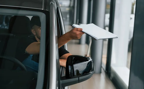 Sitting Vehicle Holding Document Delivery Man Uniform Indoors Car Order — Stock Photo, Image