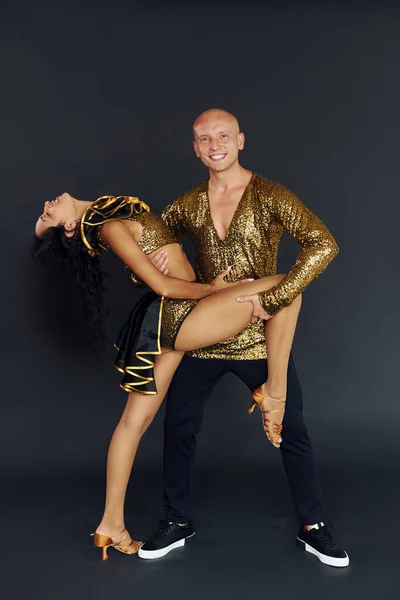 Professional dancers. Cheerful couple is together indoors.