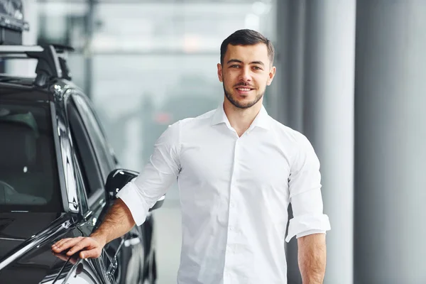 Jongeman Wit Shirt Binnen Met Moderne Nieuwe Auto — Stockfoto