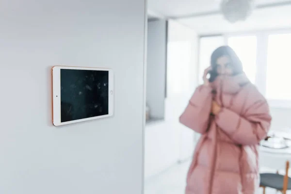 Climate control. Young woman is indoors in smart house room at daytime.