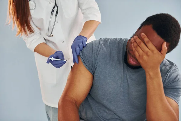 女医生在医院给非洲裔美国男子注射疫苗 — 图库照片