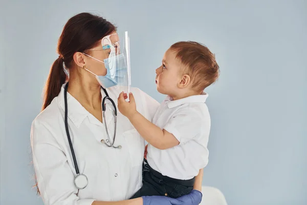 Young Nurse White Coat Stethoscope Holds Little Boy Hands — Stock Photo, Image
