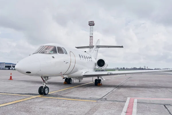 Front view. Turboprop aircraft parked on the runway at daytime.