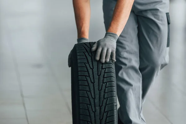 Neumático Suelo Hombre Uniforme Trabaja Autosalón Durante Día —  Fotos de Stock