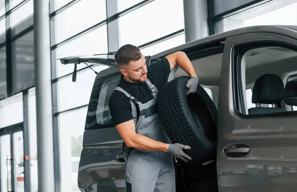 Tire Hands Man Uniform Working Autosalon Daytime Stock Photo