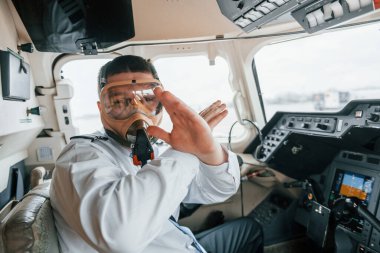 Oksijen maskeli. Yolcu uçağının pilotu. Kalkışa hazırlanılıyor..