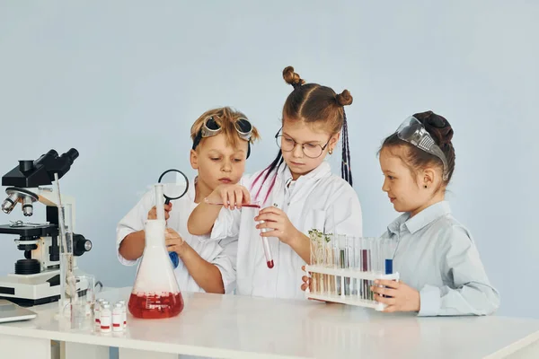 Two Young Characters With Science Club Equipment On White Background Male  And Female Teens Wearing White Coats And Smiling Set Of Scientific Items  With Microscope Science Book Tubes Formulas Stock Illustration 